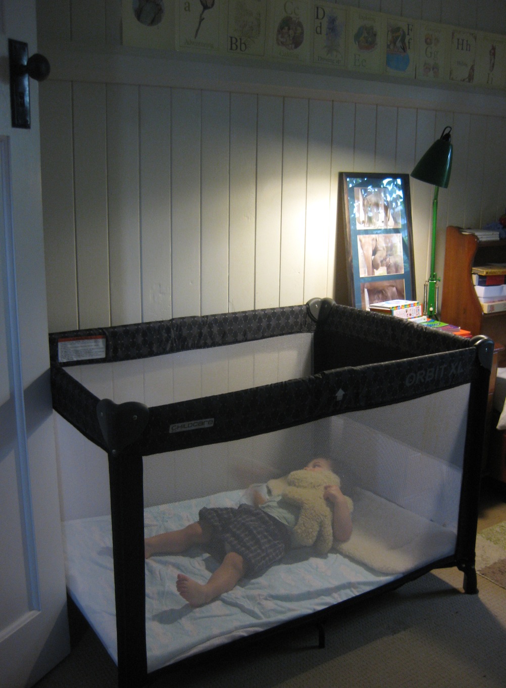 baby sleeping in travel cot